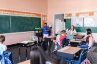 Teacher monitoring students inside a classroom while school lockdown procedures are in place.
