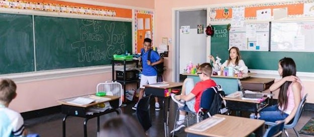 Teacher monitoring students inside a classroom while school lockdown procedures are in place.