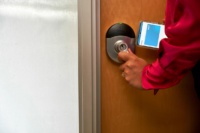User entering a room using a Schlage lock.