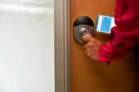 User entering a room using a Schlage lock.