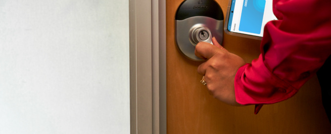 User entering a room using a Schlage lock.